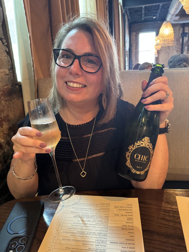 Stephanie drinking sparkling wine.